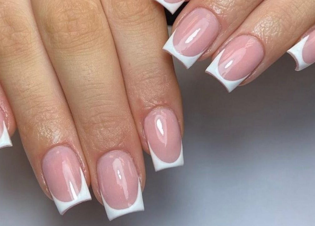 Beautiful French manicure at Lux Beauty, Cannock, England, GB. Perfectly polished nails in close-up.