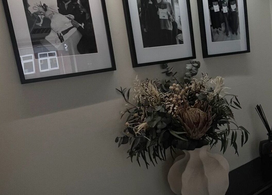 Elegant floral arrangement beneath framed photos at Lux Beauty in Cannock, England, GB.