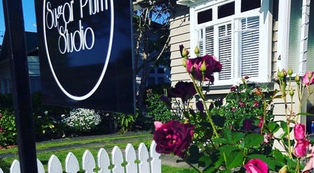 Sugar Plum Studio front view with roses, located in Hamilton, Waikato, NZ.