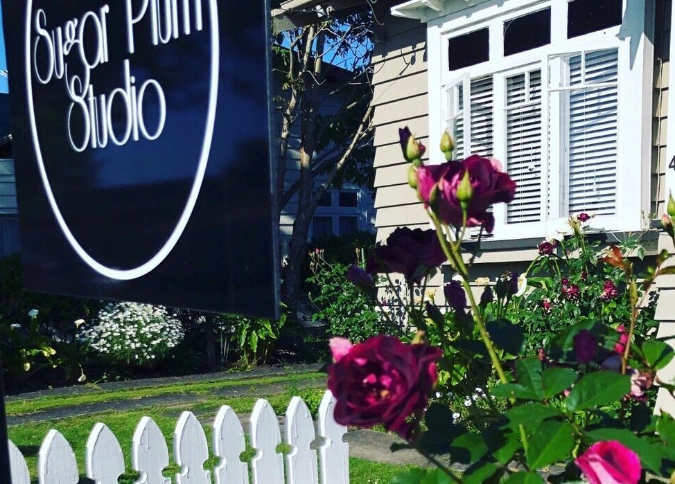 Sugar Plum Studio entrance with roses and white picket fence in Hamilton, Waikato, NZ.