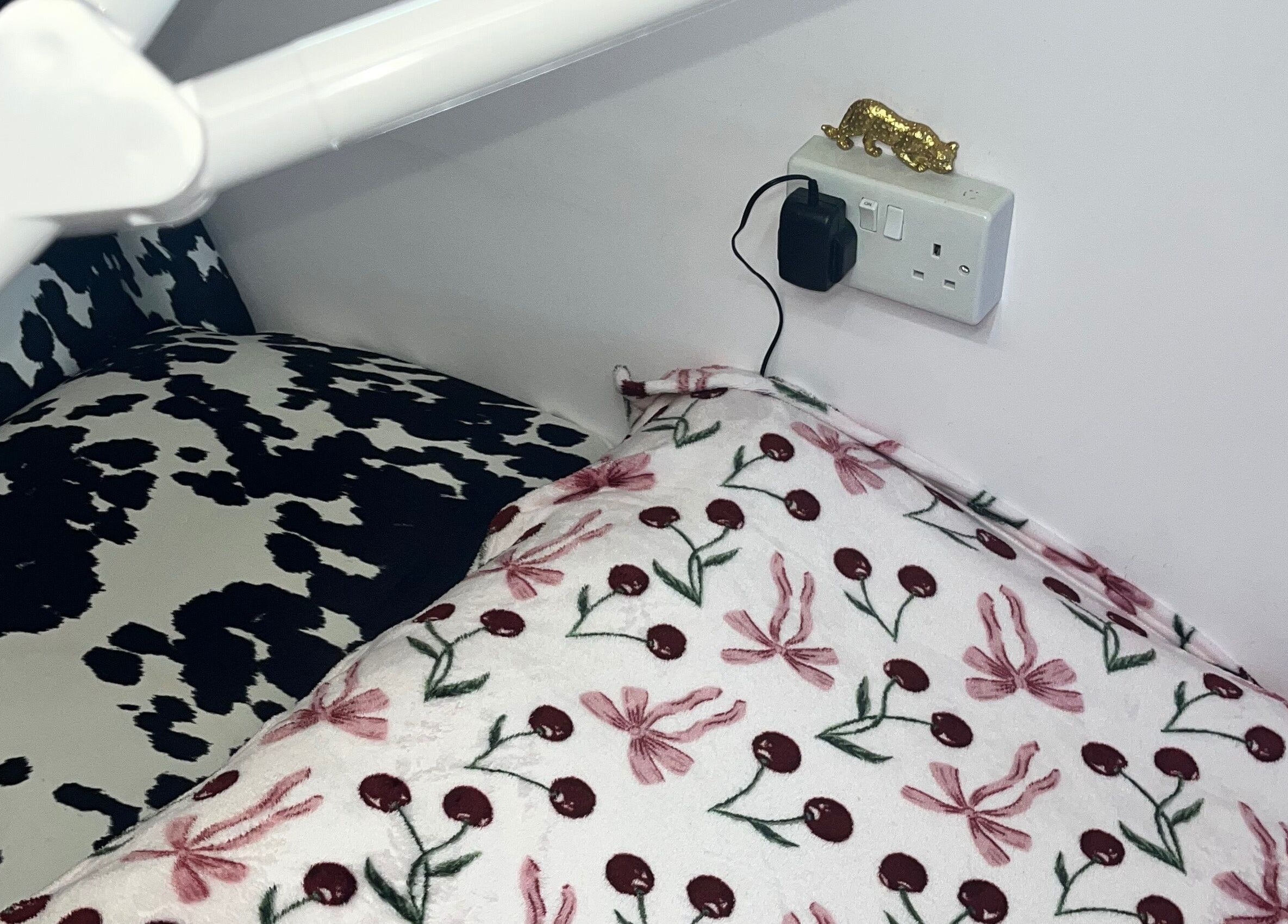 Comfortable seating area at PA Beauty, Highworth, England, GB, with floral and cow-print patterns.