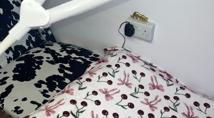 Comfortable seating area at PA Beauty, Highworth, England, GB, with floral and cow-print patterns.