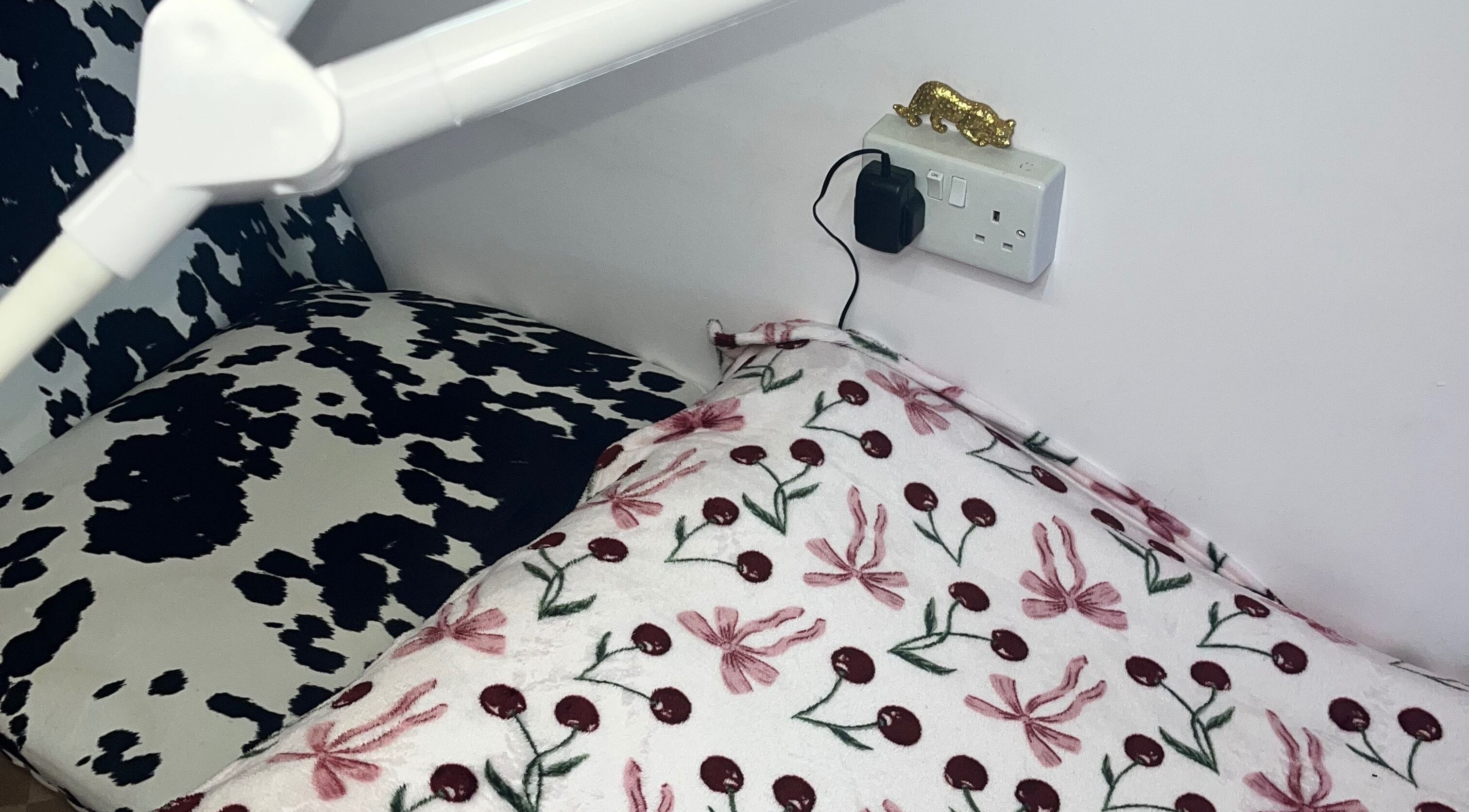 Comfortable seating area at PA Beauty, Highworth, England, GB, with floral and cow-print patterns.