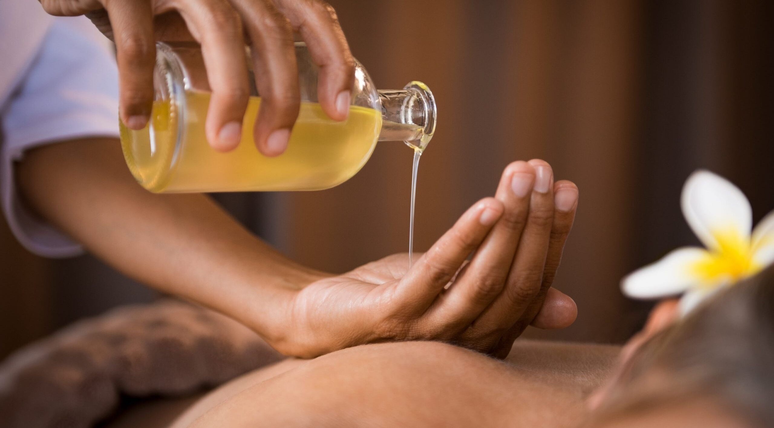 Massage oil being poured at Tranquil Treatments, Irvine, Scotland, GB for relaxation therapy.