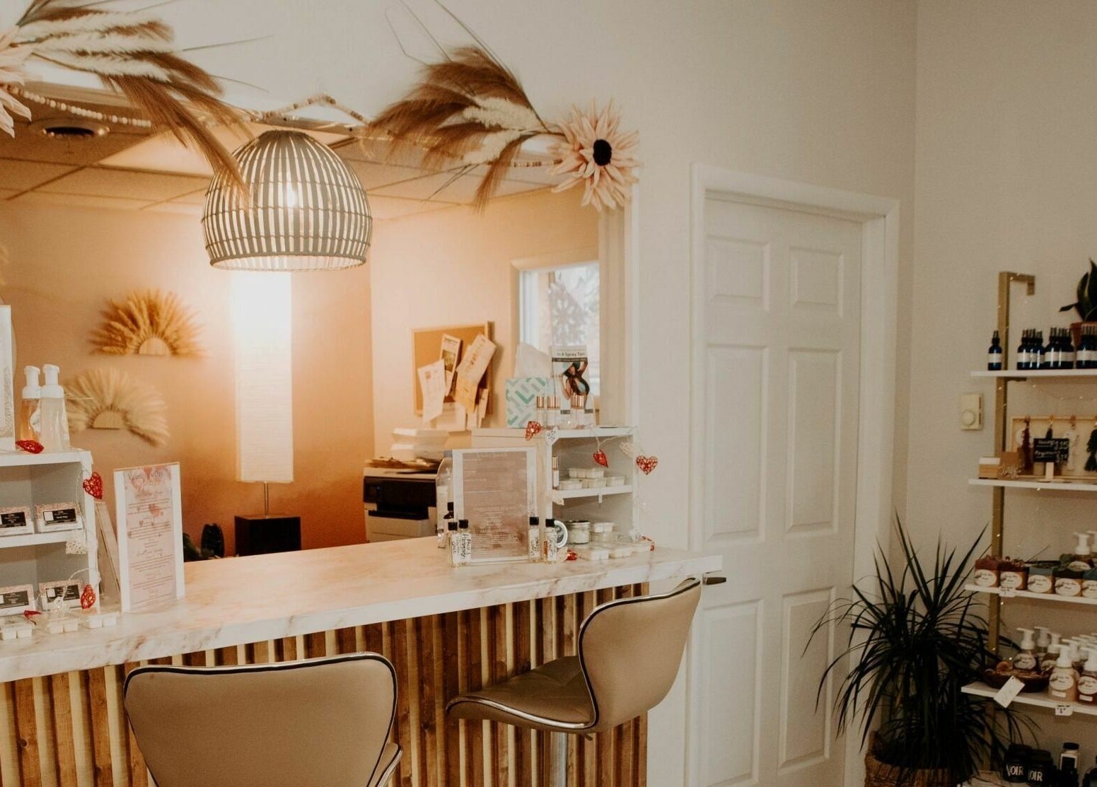 Reception area of Glow Massage and Esthetics in Pottsville, Pennsylvania, US with stylish decor and products.