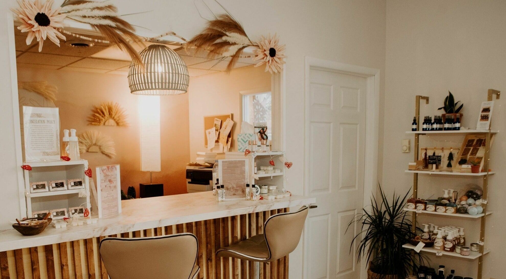 Reception area of Glow Massage and Esthetics in Pottsville, Pennsylvania, US with stylish decor and products.