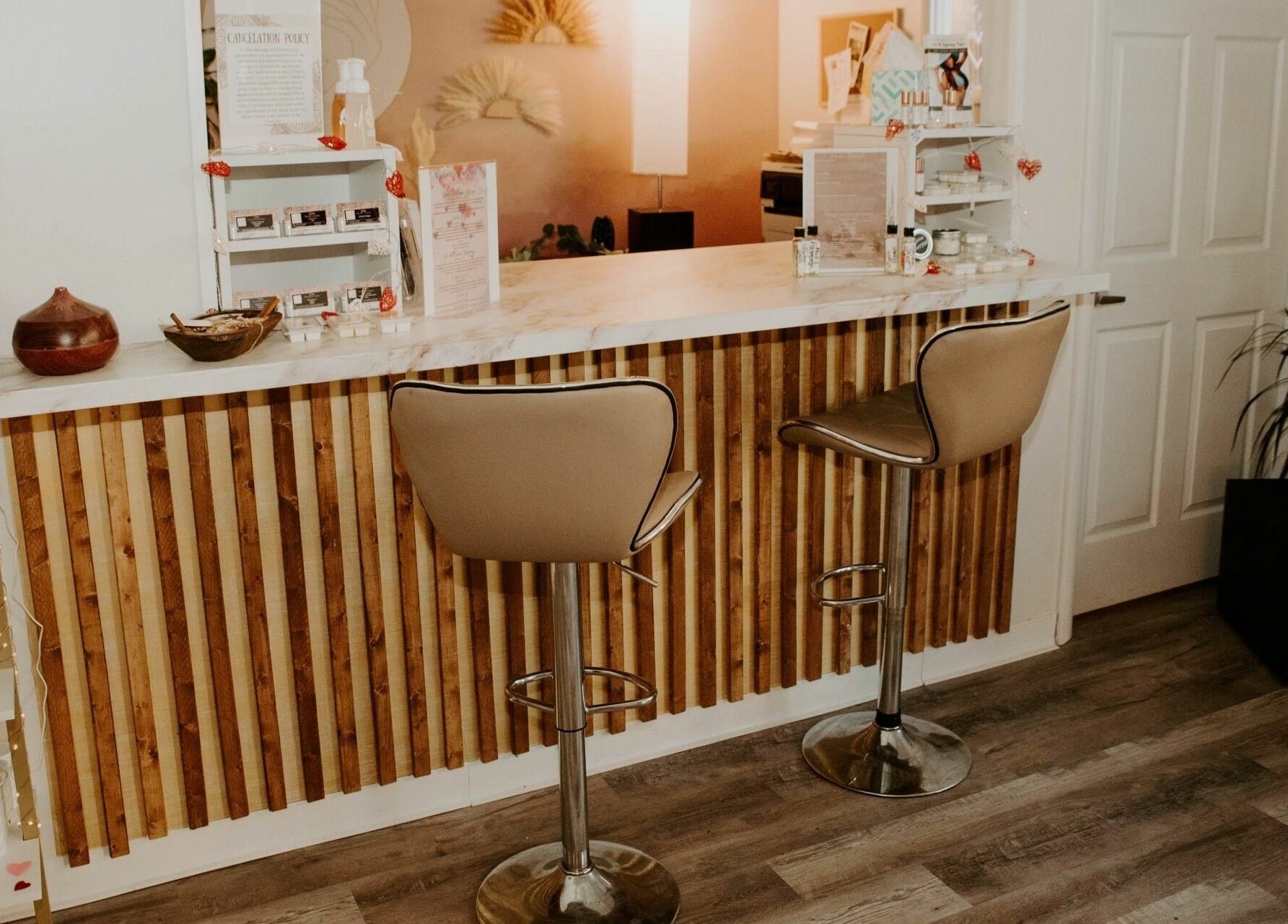 Chic reception area at Glow Massage and Esthetics in Pottsville, Pennsylvania, US, featuring modern decor and seating.