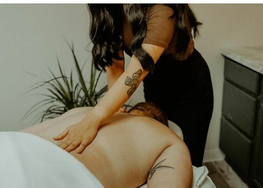 Massage therapist at Glow Massage and Esthetics in Pottsville, Pennsylvania, US, providing a relaxing back massage.