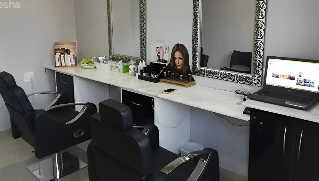 Modern beauty salon station at Roop Beauty and Threading, Centurion, Gauteng, ZA with stylish chairs and mirrors.