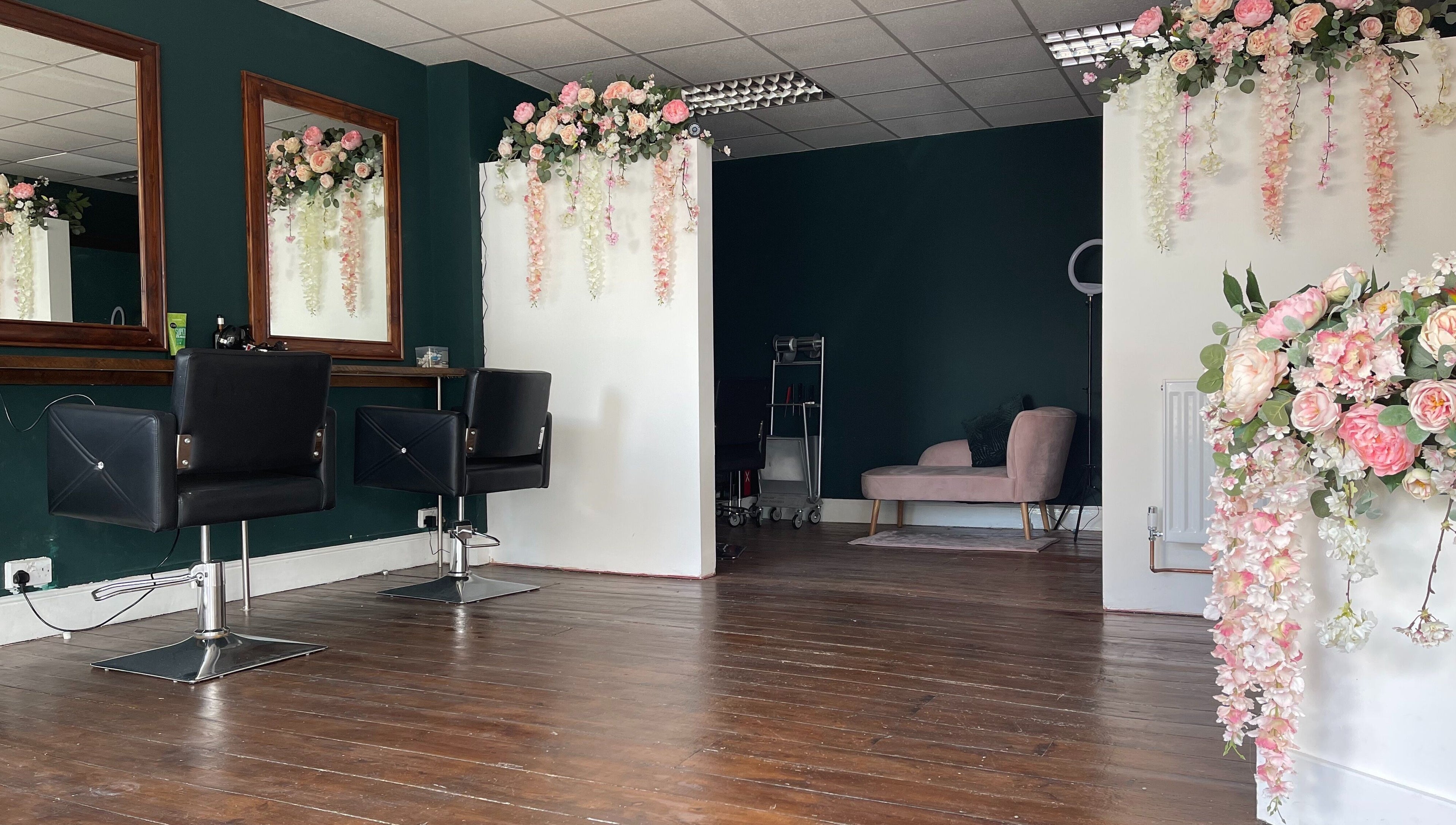 Chic interior of MK Salon in Lowestoft, England, GB, featuring floral decor and stylish salon chairs.