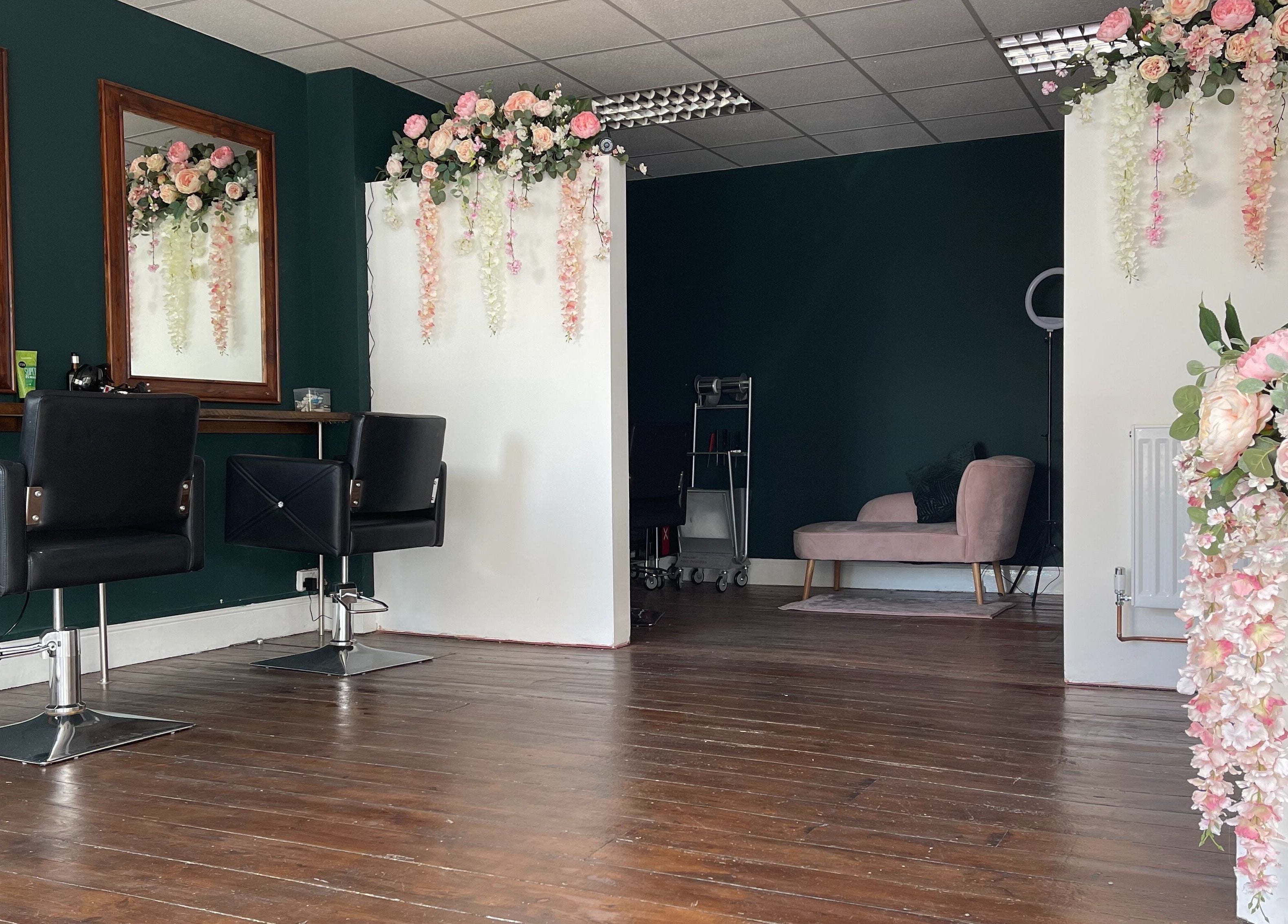 Chic interior of MK Salon in Lowestoft, England, GB, featuring floral decor and stylish salon chairs.