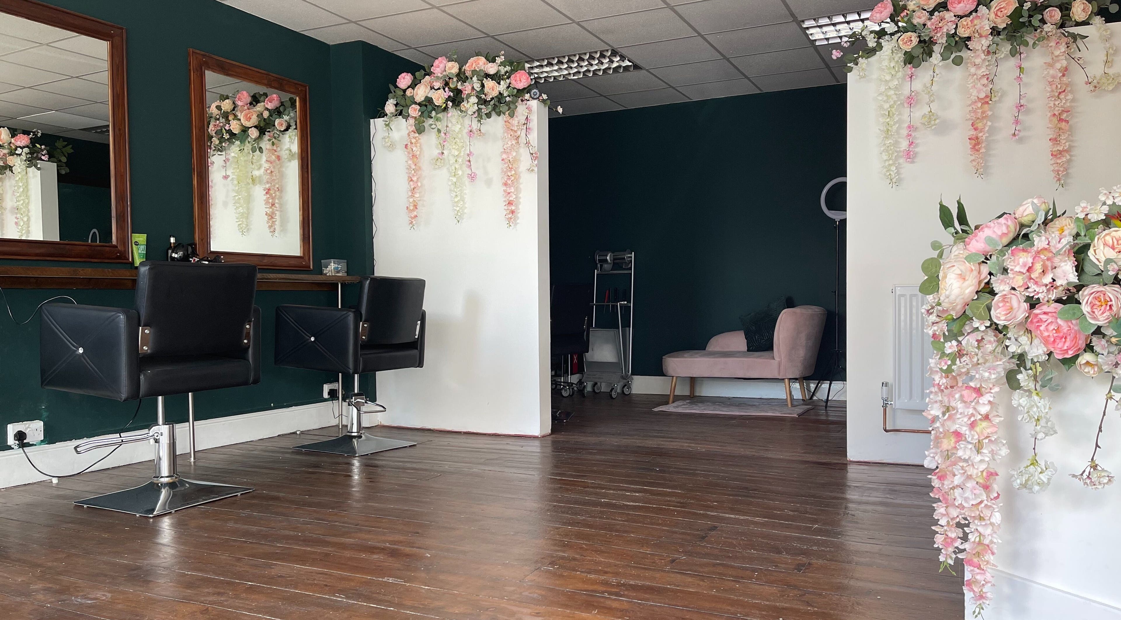 Chic interior of MK Salon in Lowestoft, England, GB, featuring floral decor and stylish salon chairs.
