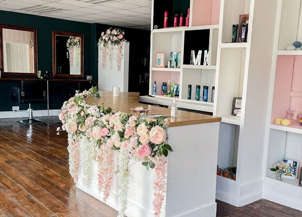 MK Salon reception in Lowestoft, England, GB adorned with elegant floral decor and stylish shelving.