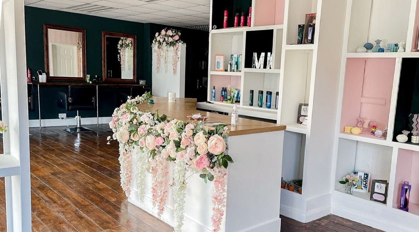 MK Salon reception in Lowestoft, England, GB adorned with elegant floral decor and stylish shelving.