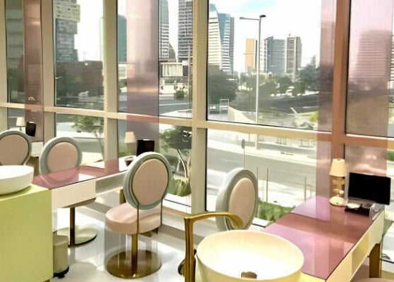 Chic interior view of Le Meme Spa, Manarat Lusail Tower, Doha, with elegant decor and cityscape window view.