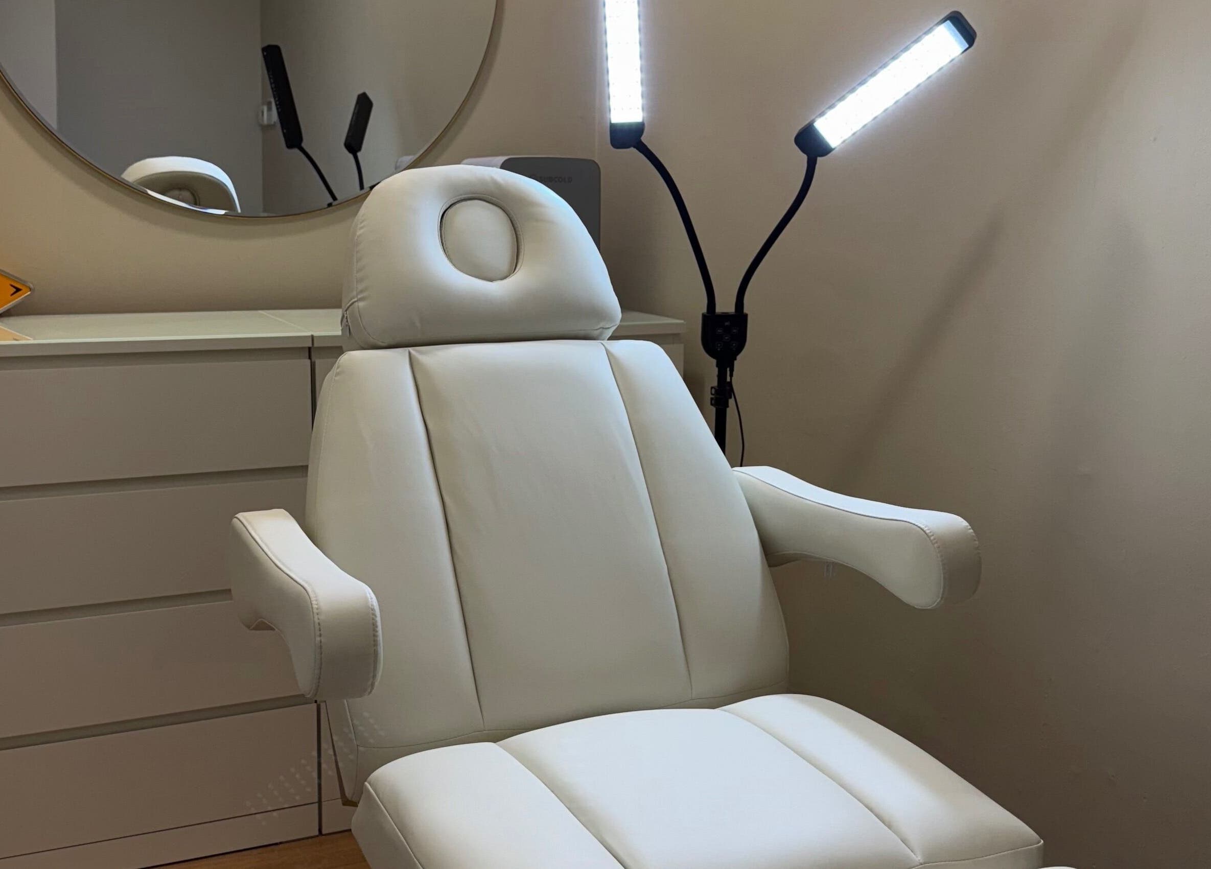 Modern treatment chair at Quinns Tanning and Aesthetics in London, England, GB, showcasing a serene environment.
