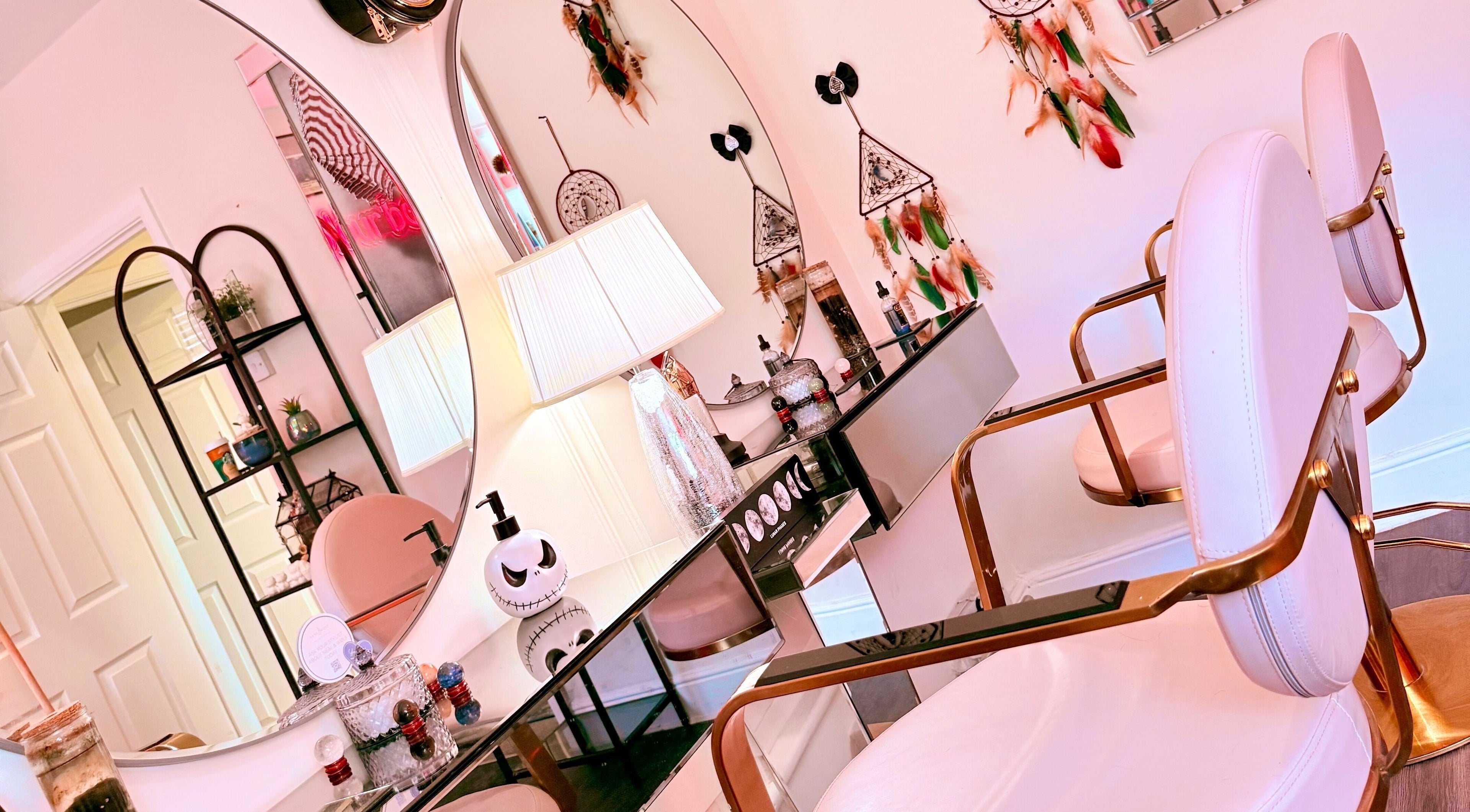 Chic beauty salon interior at Namastique, Hull, England, GB, featuring stylish pink chairs and elegant decor.