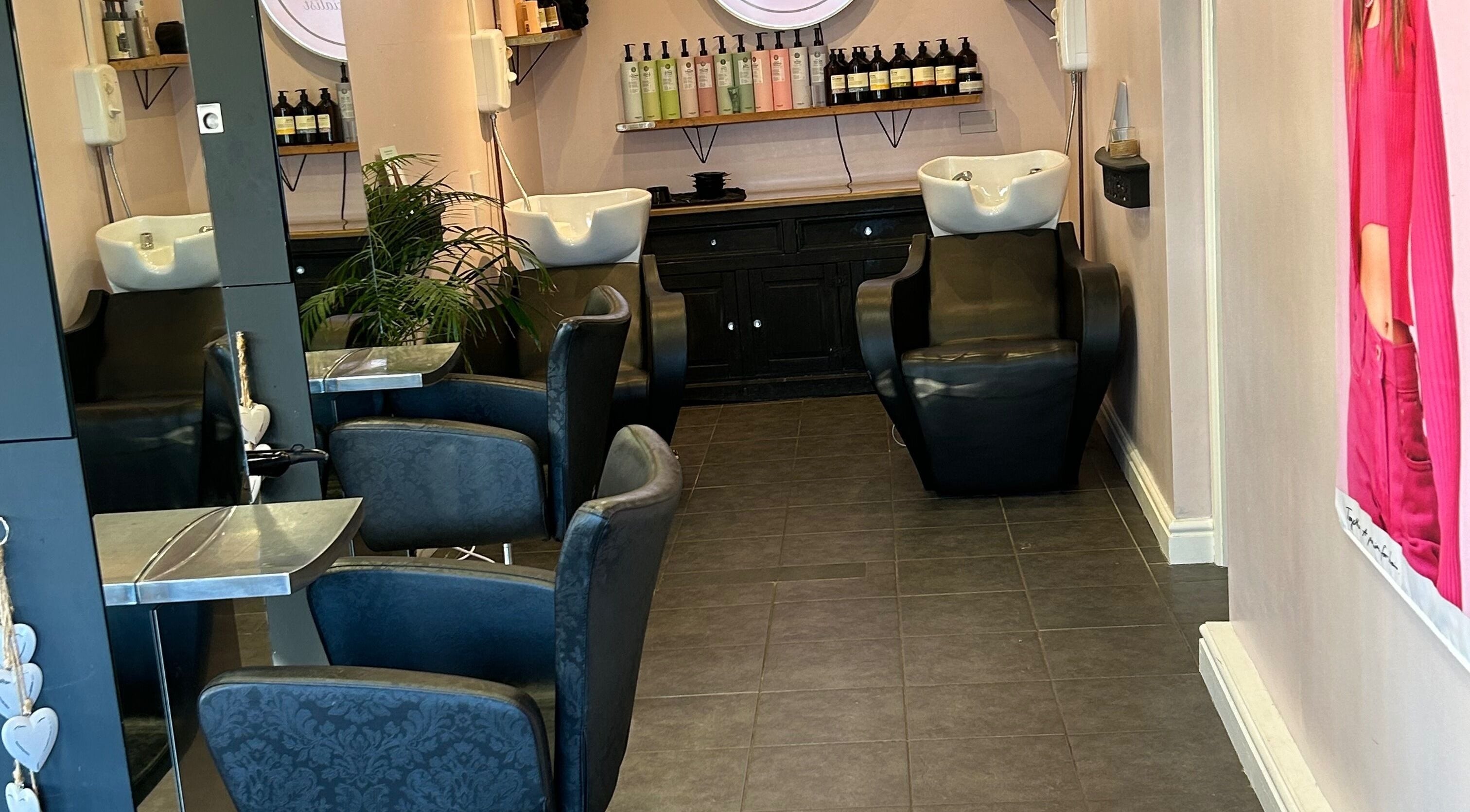 Modern interior of Cheryl Price Hairdressing Tredington, Shipston-on-stour, GB with stylish chairs and washbasins.