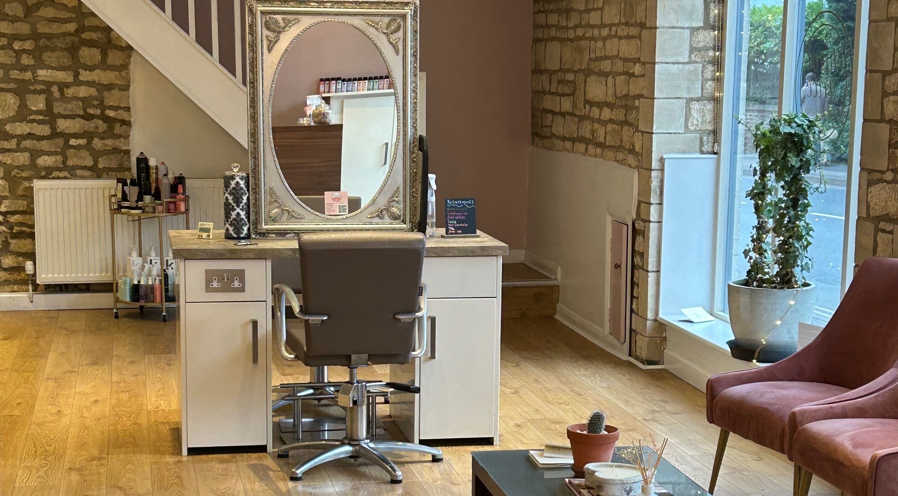 Charming interior at Cheryl Price Hairdressing Prestbury, featuring rustic decor and styling chair, located Prestbury, England, GB.