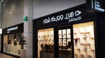 Exterior of The Hair Workshop in Abu Dhabi, AE, showcasing modern signage and stylish entrance.