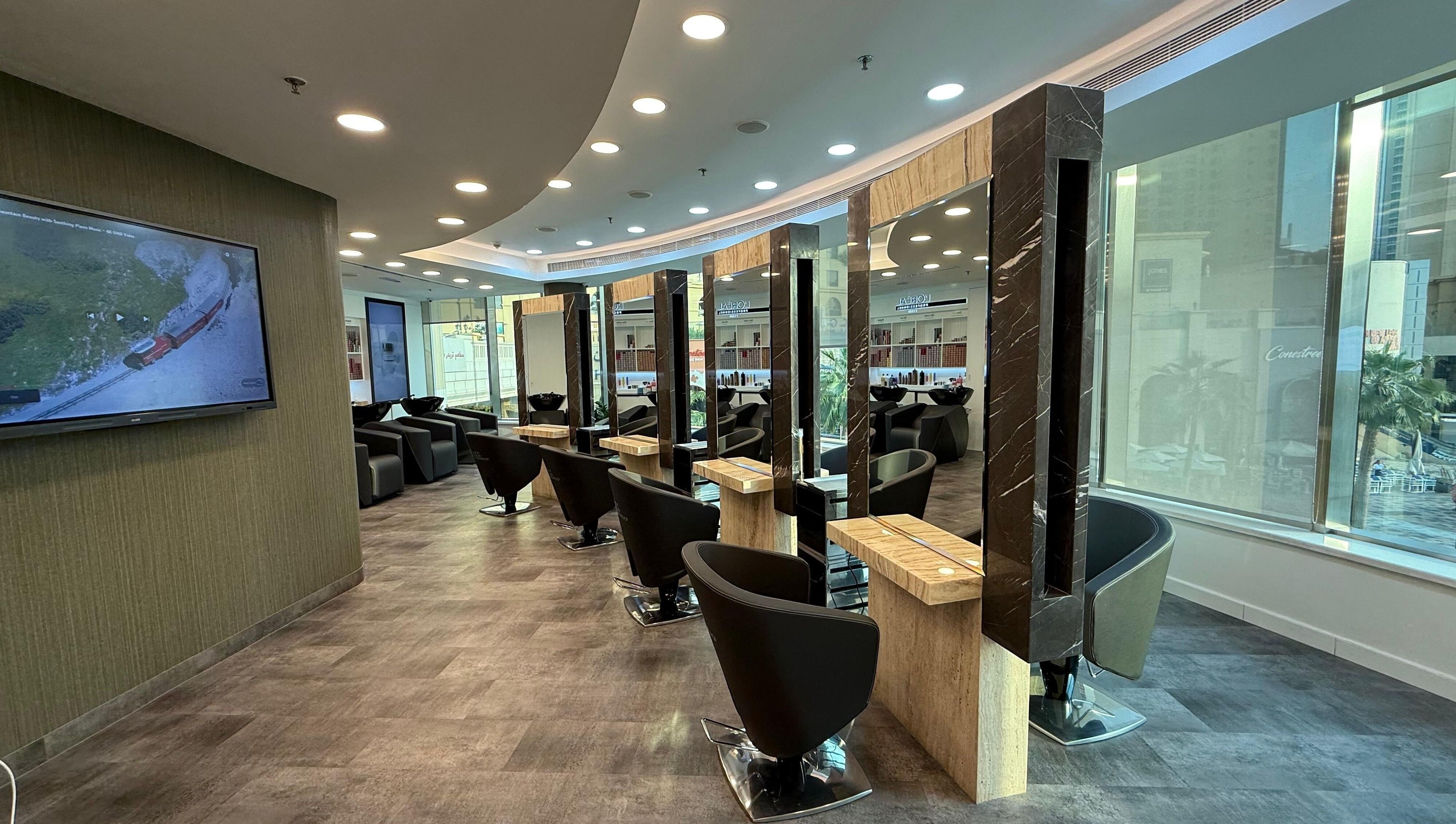 Elegant salon setup at The Hair Workshop Extensions Hair Couture, Dubai, Dubai, AE, featuring stylish chairs and mirrors.