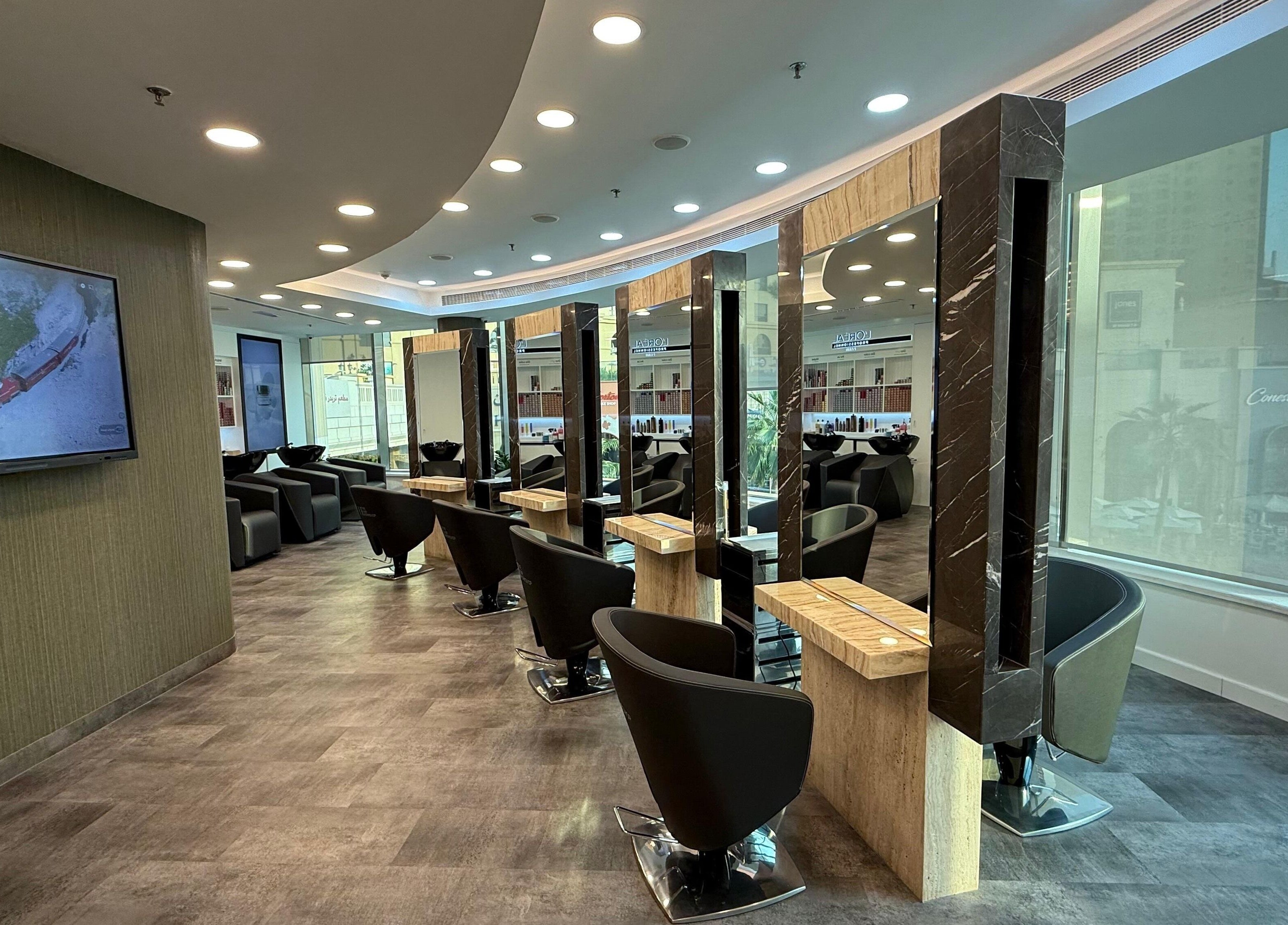 Elegant salon setup at The Hair Workshop Extensions Hair Couture, Dubai, Dubai, AE, featuring stylish chairs and mirrors.