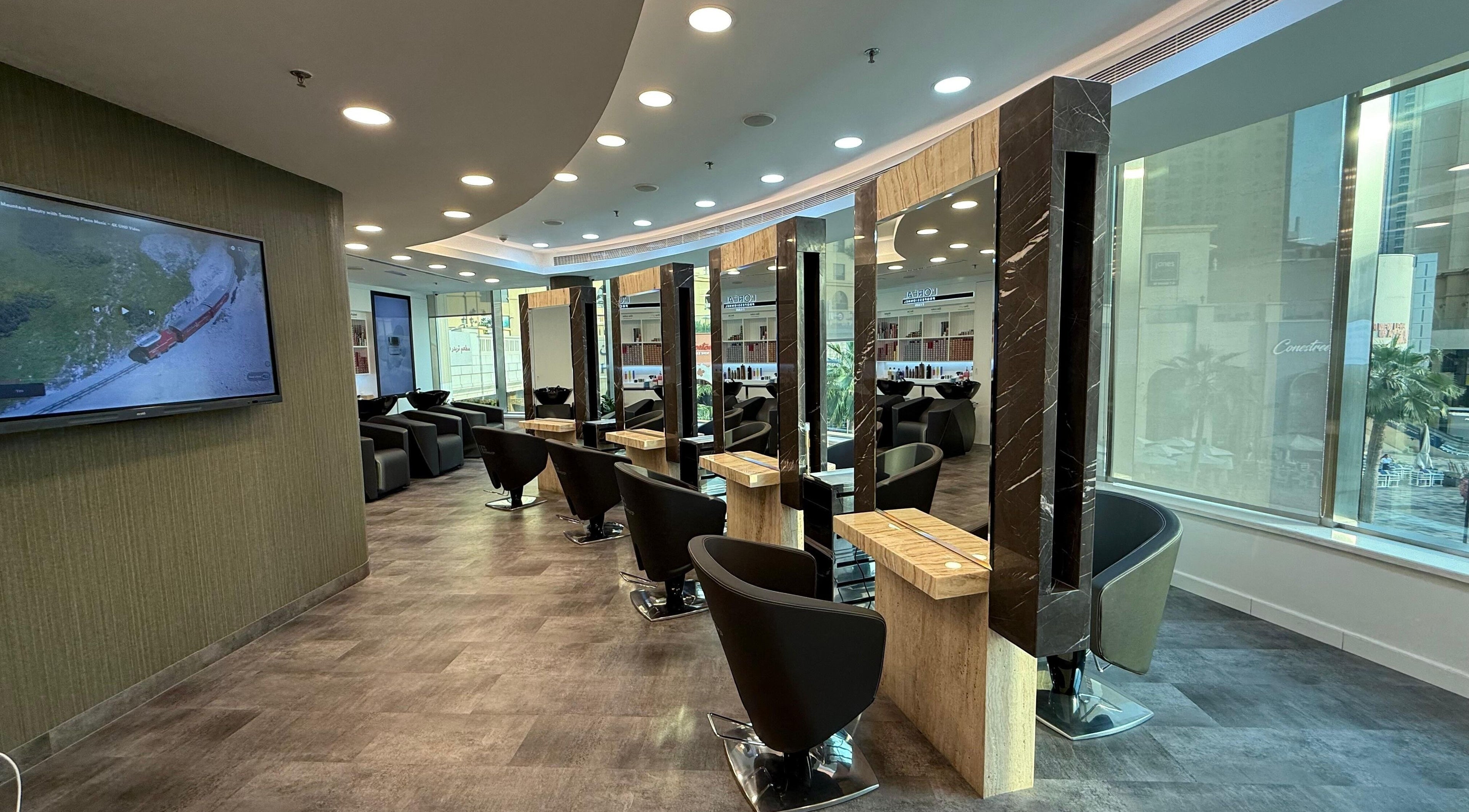 Elegant salon setup at The Hair Workshop Extensions Hair Couture, Dubai, Dubai, AE, featuring stylish chairs and mirrors.