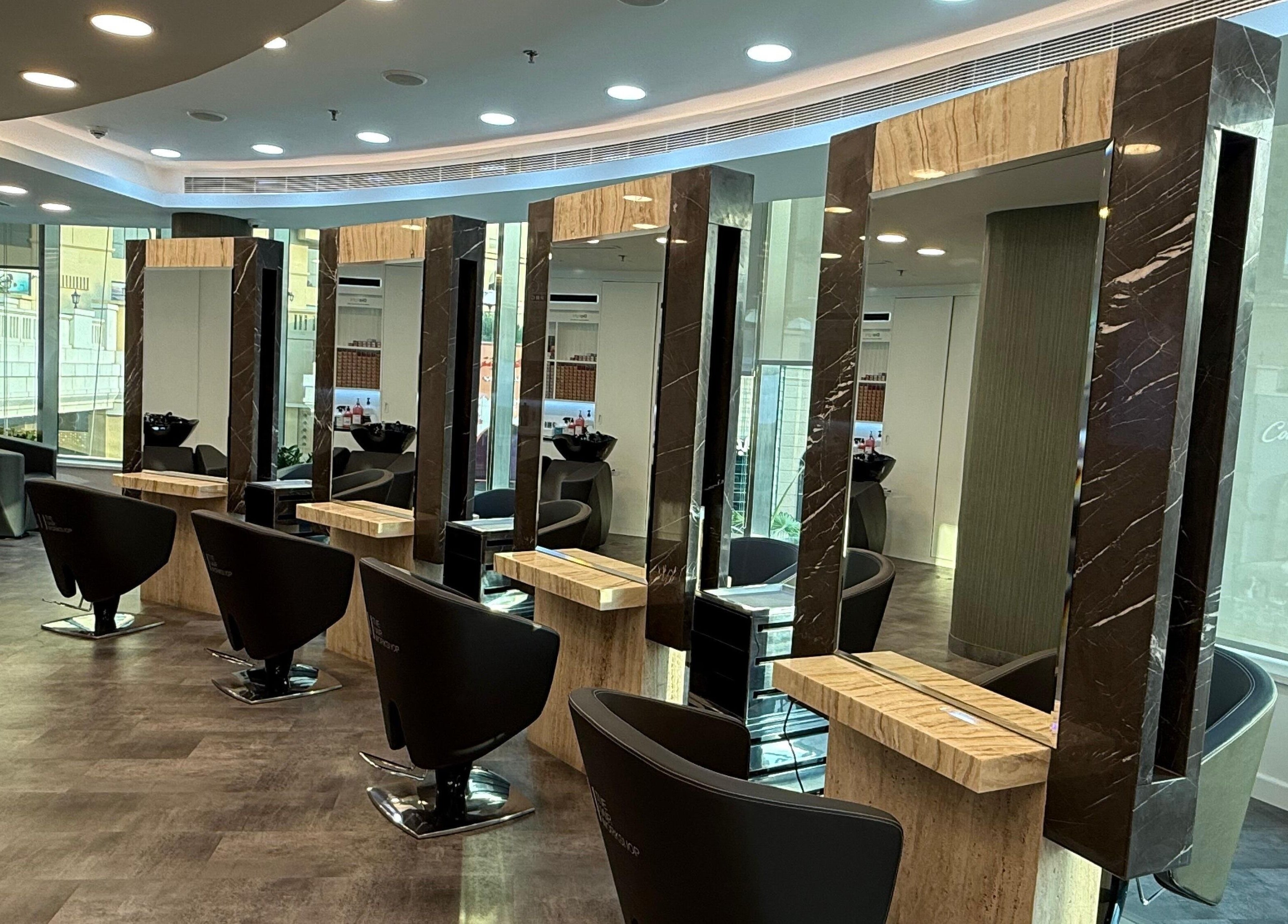 Modern salon setup at The Hair Workshop Extensions Hair Couture, Dubai, Dubai, AE, featuring elegant styling stations.