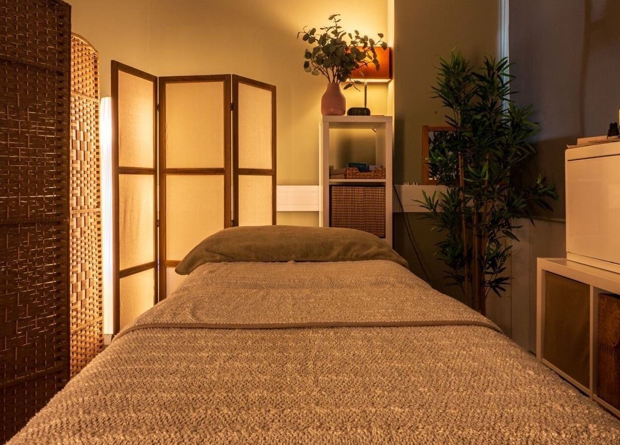 Tranquil therapy room at Heal Studio, London, England GB, featuring a cozy bed and ambient lighting.