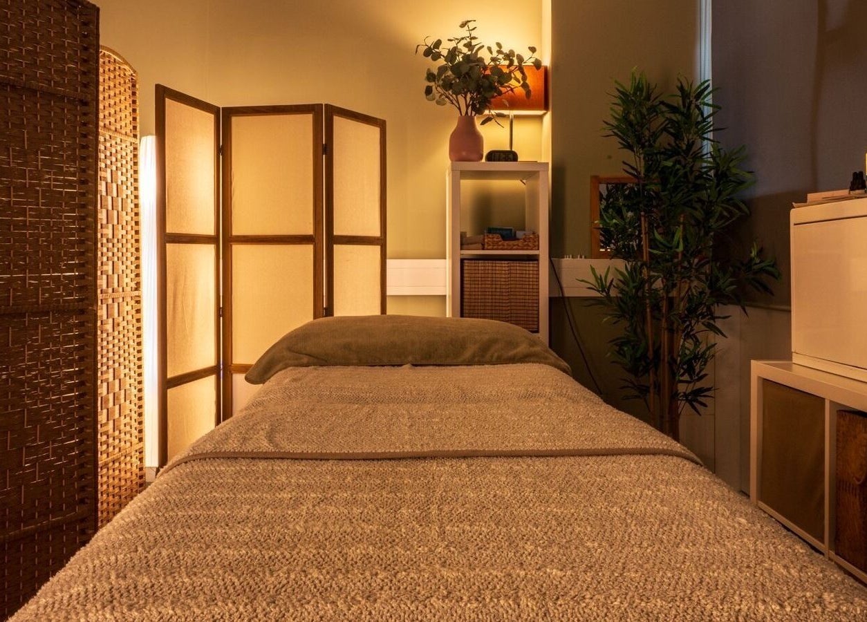 Tranquil therapy room at Heal Studio, London, England GB, featuring a cozy bed and ambient lighting.