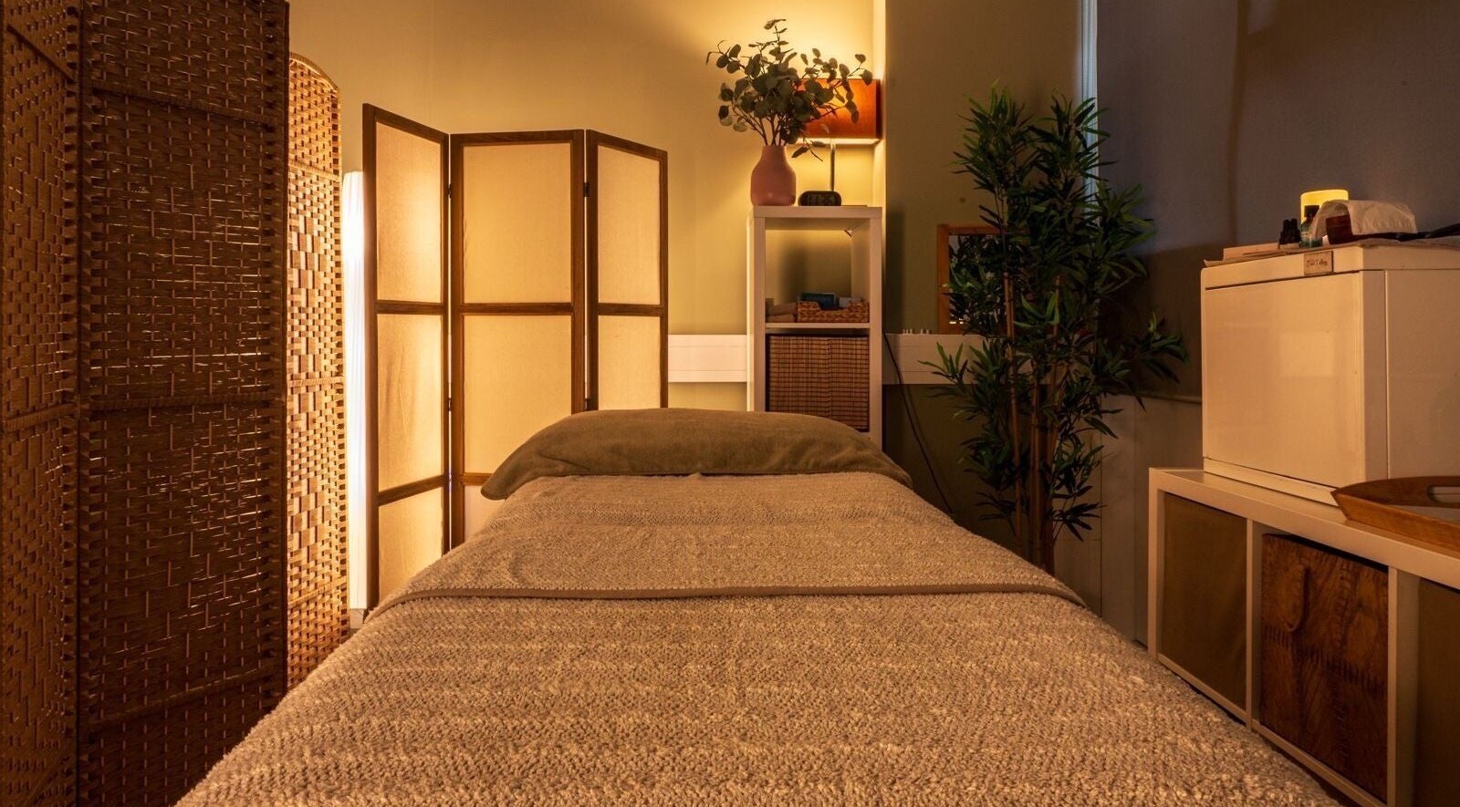 Tranquil therapy room at Heal Studio, London, England GB, featuring a cozy bed and ambient lighting.