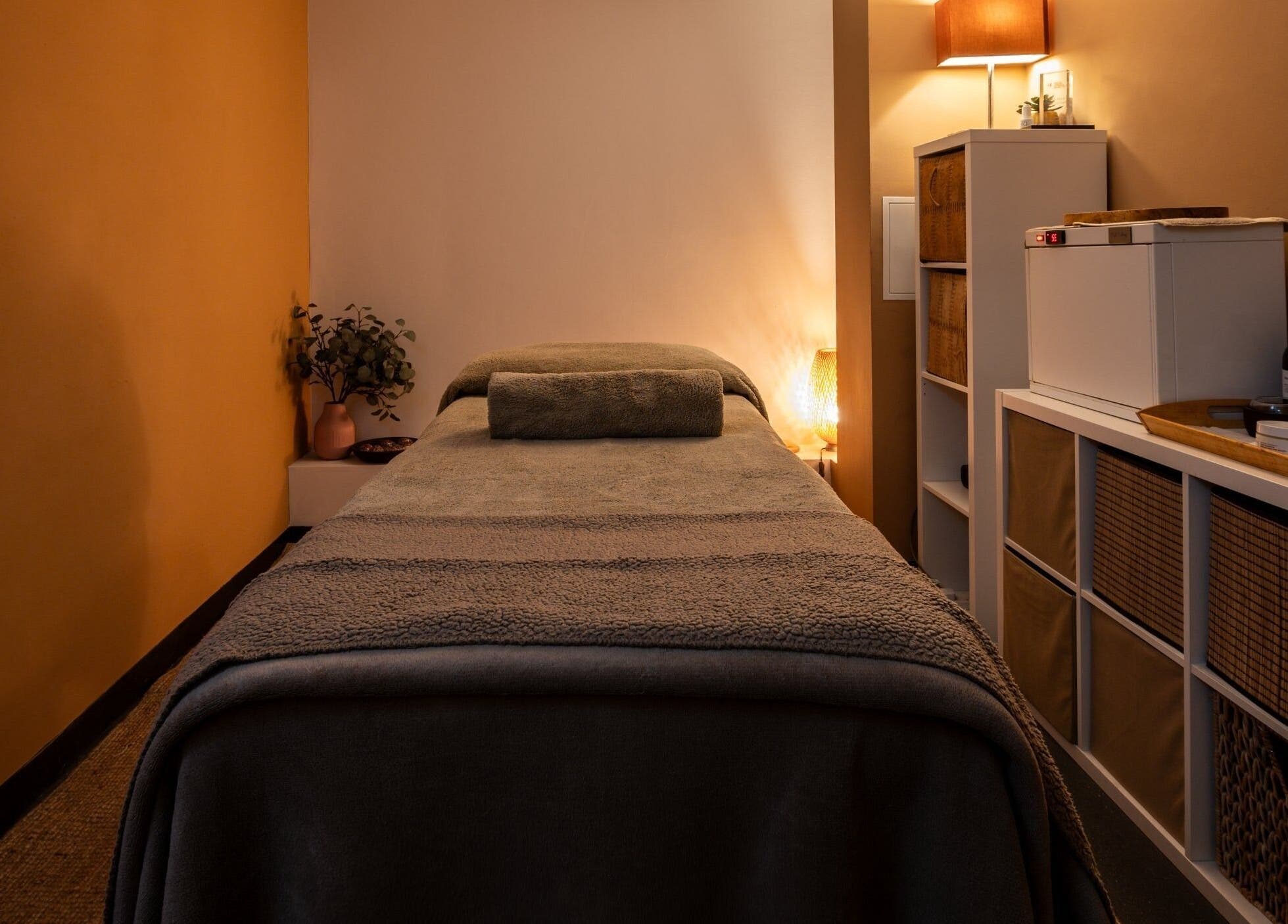 Relaxing massage room at Heal Studio (Formerly Bathhaus Spa), London, England, GB with warm lighting.