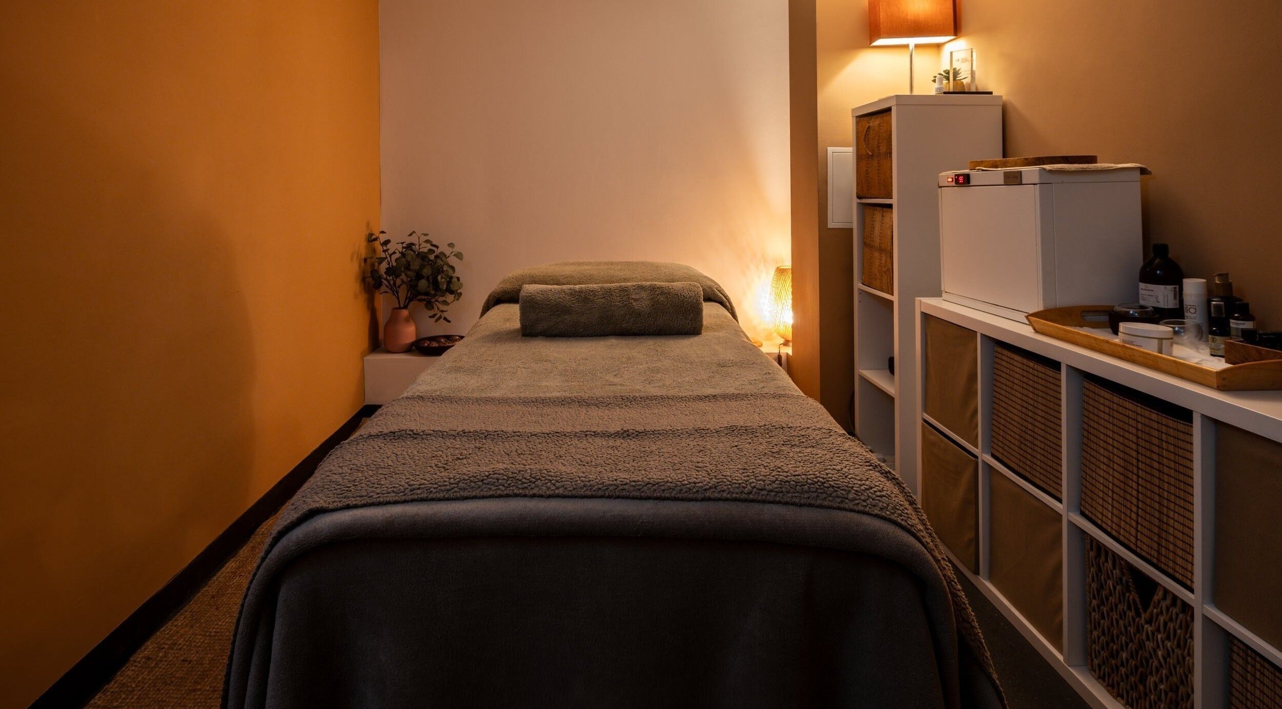 Relaxing massage room at Heal Studio (Formerly Bathhaus Spa), London, England, GB with warm lighting.