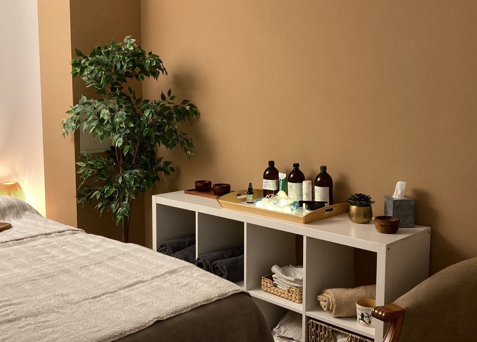 Cozy treatment room at Heal Studio, London, England, GB, with decor and massage essentials.