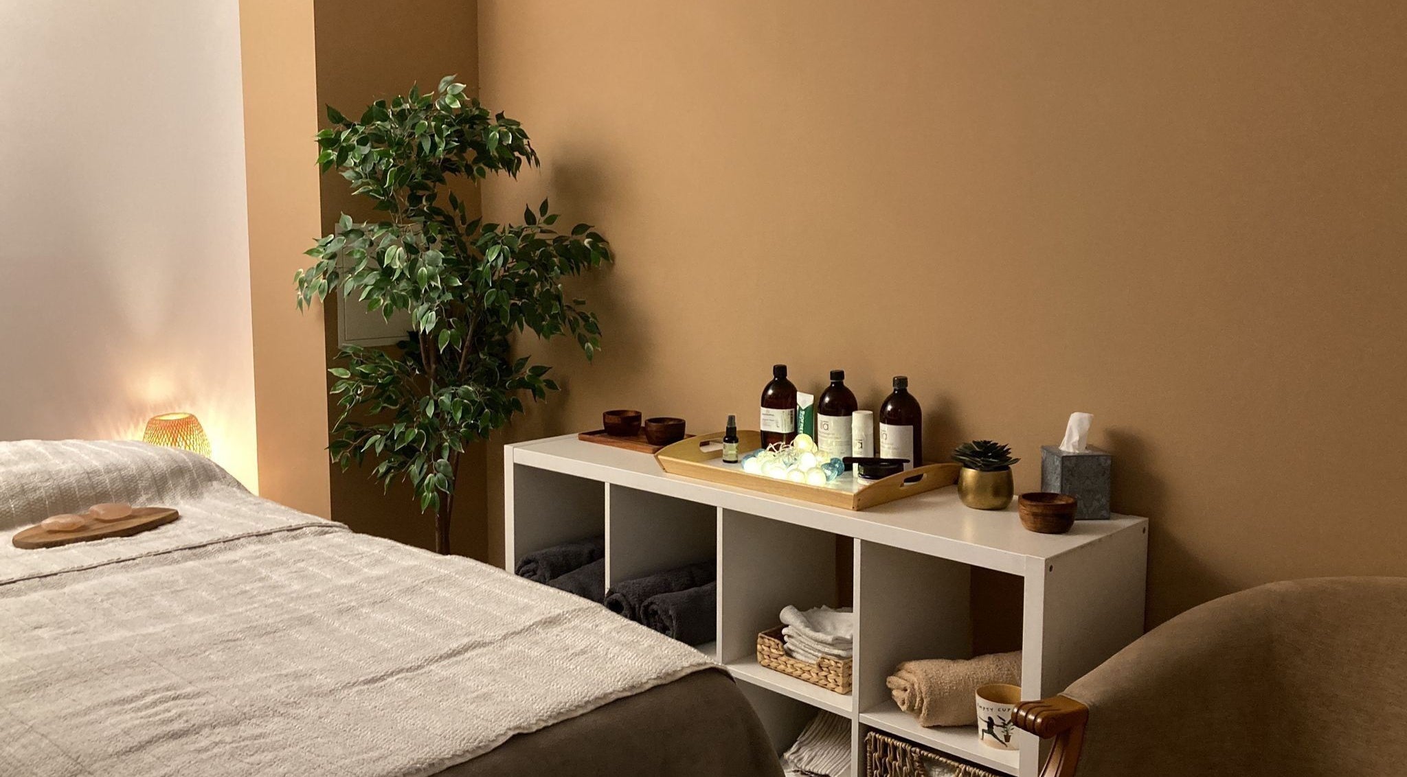 Cozy treatment room at Heal Studio, London, England, GB, with decor and massage essentials.