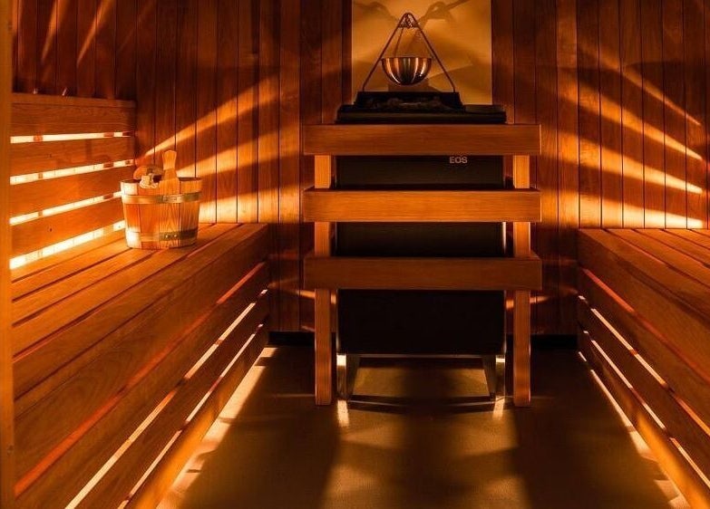 Cozy sauna room at Heal Studio (Formerly Bathhaus Spa), London, England, GB, featuring wooden interiors and warm lighting.