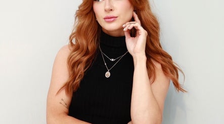 Stylish woman with red hair at Rachel Crowe Makeup, Dundee, Scotland, GB, showcasing elegant jewelry.