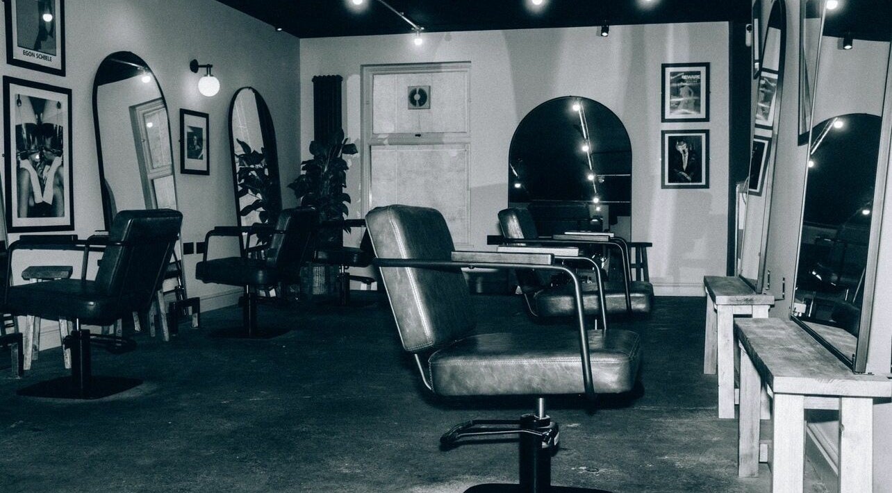 Modern salon chairs and mirrors at Blake Edwards, Leicester, England, GB, showcasing a sleek interior design.