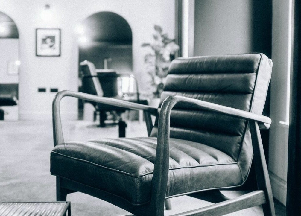 Sophisticated interior with a leather chair at Blake Edwards, Leicester, England, GB, exuding comfort and style.