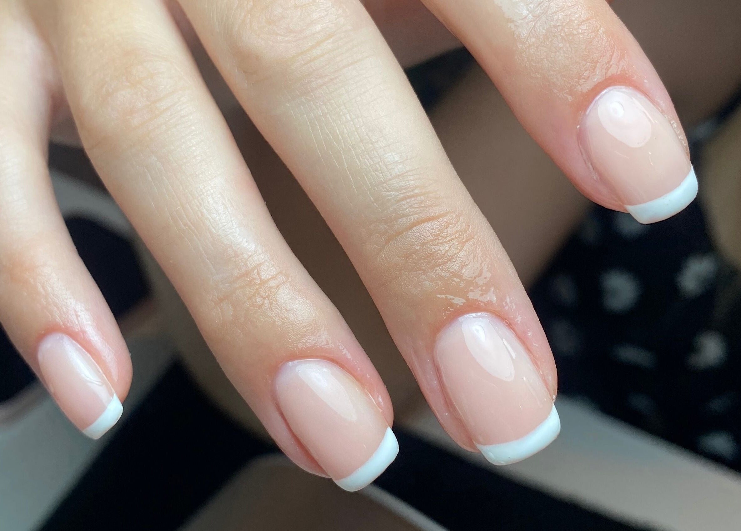 Close-up of elegant French manicure at Bombshell Boutique Beauty, Bracknell, England, GB.