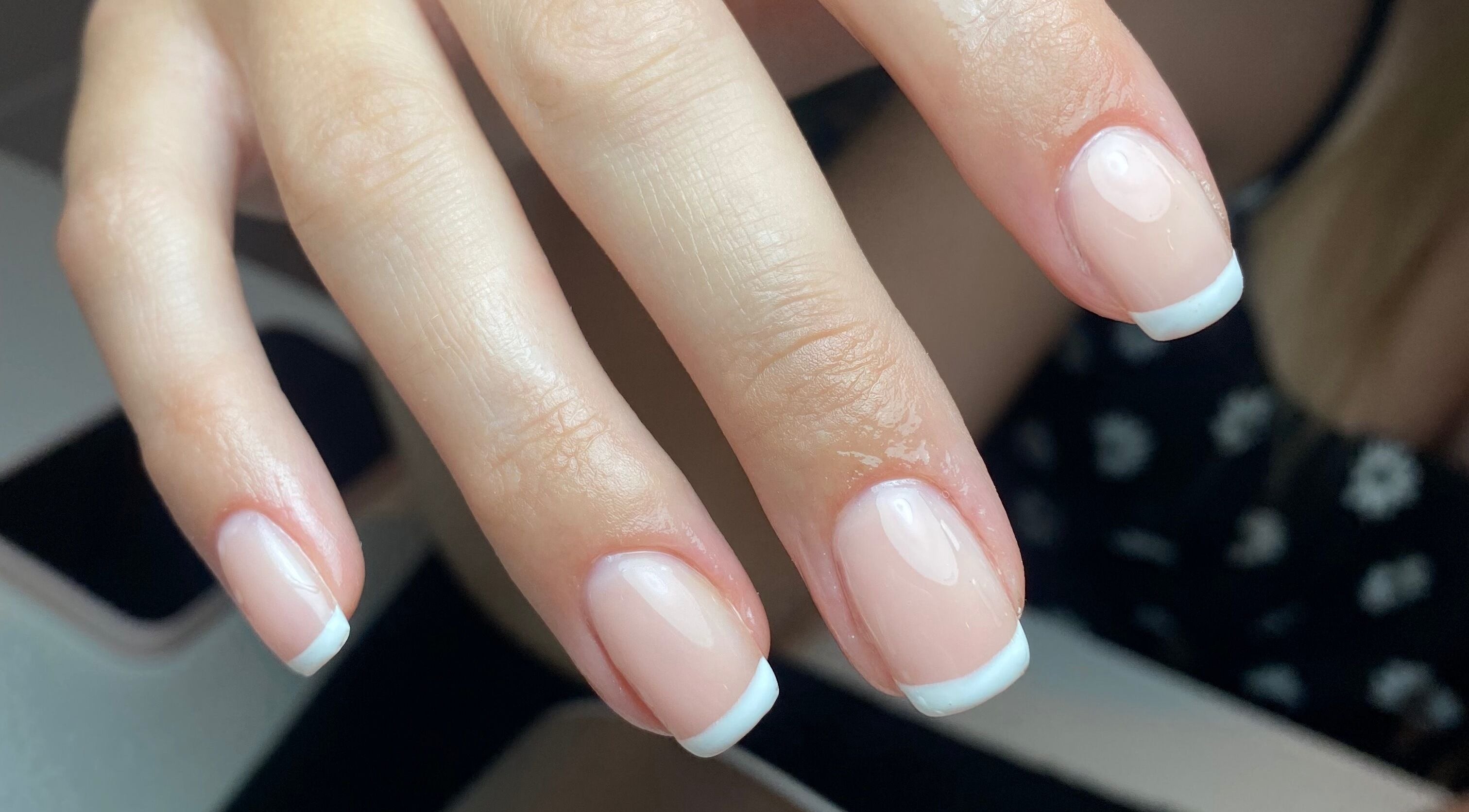 Close-up of elegant French manicure at Bombshell Boutique Beauty, Bracknell, England, GB.