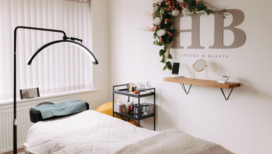H B R O W S & B E A U T Y treatment room with table and decor, Lightwater, England, GB.