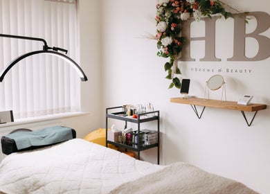 H B R O W S & B E A U T Y treatment room with table and decor, Lightwater, England, GB.