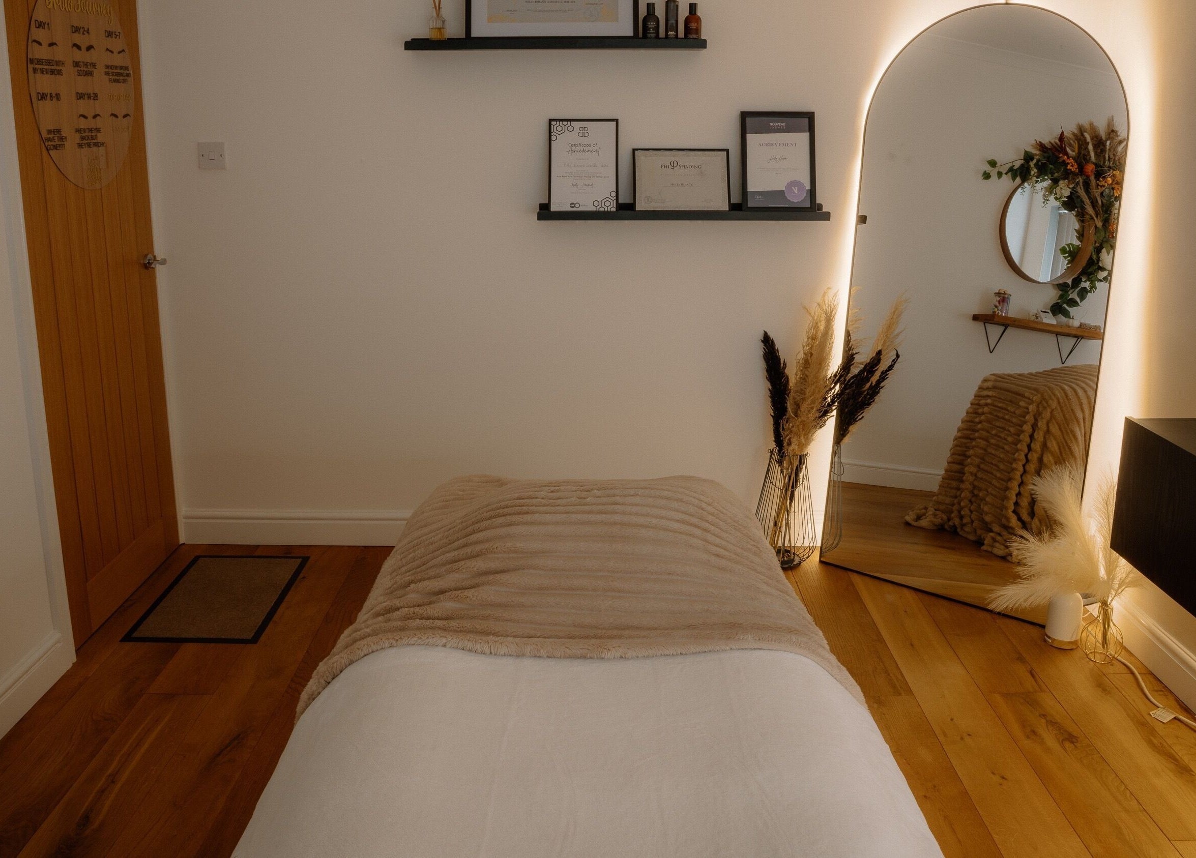 H Brows & Beauty serene treatment room in Lightwater, England, GB with ambient lighting and decor.