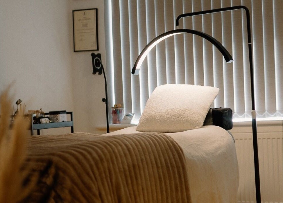 Relaxing treatment room at H Brows & Beauty in Lightwater, England, GB, featuring a cozy massage bed and soft lighting.