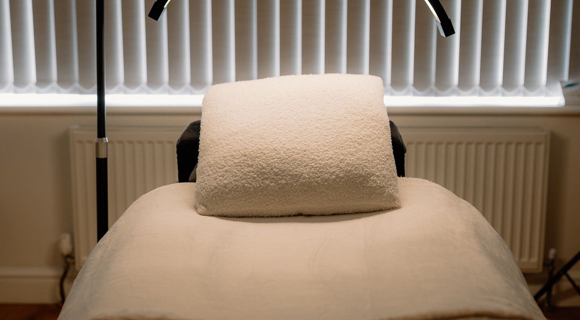 Comfortable treatment bed at H Brows & Beauty in Lightwater, England, GB, ready for relaxing wellness therapies.