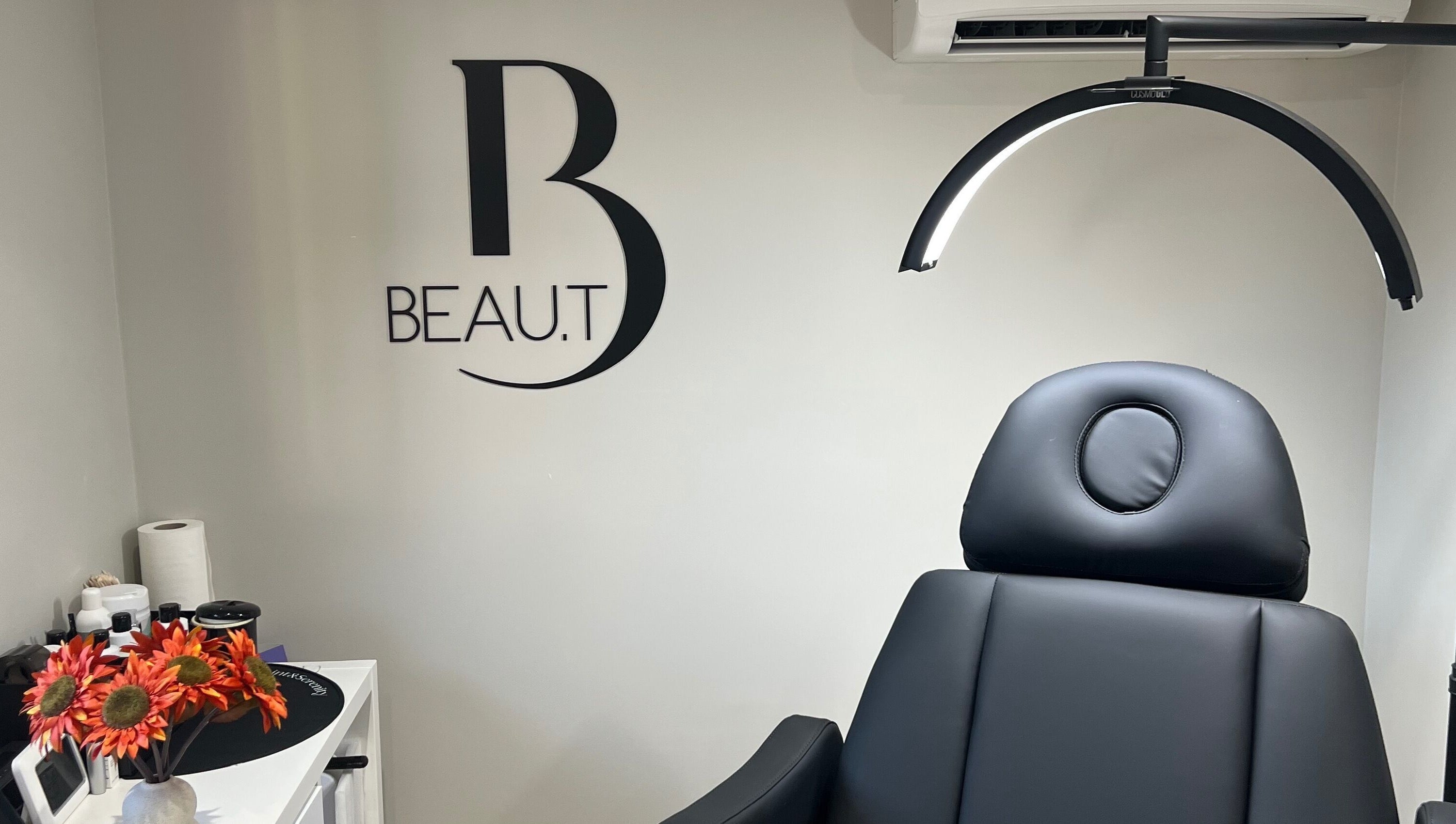 Interior of Beau.t in Southwater, England featuring a modern black spa chair and elegant decor.