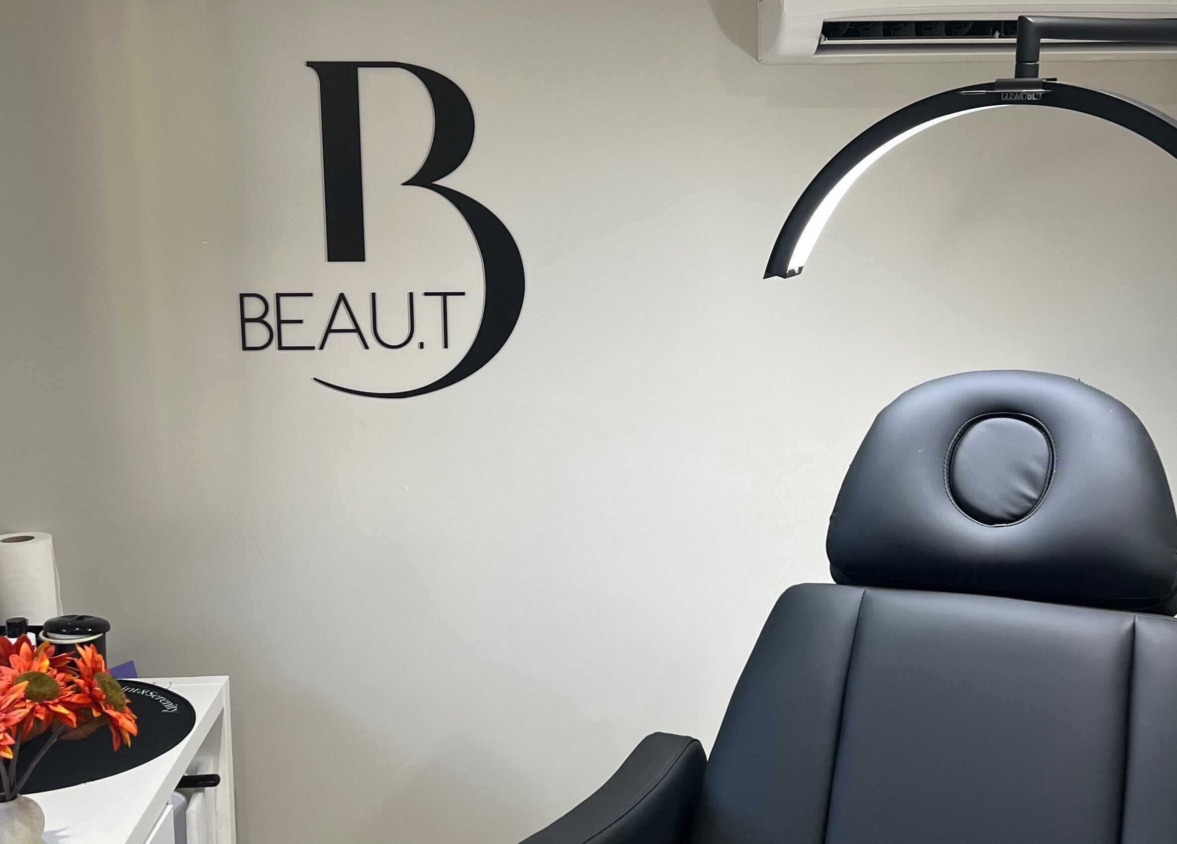 Interior of Beau.t in Southwater, England featuring a modern black spa chair and elegant decor.
