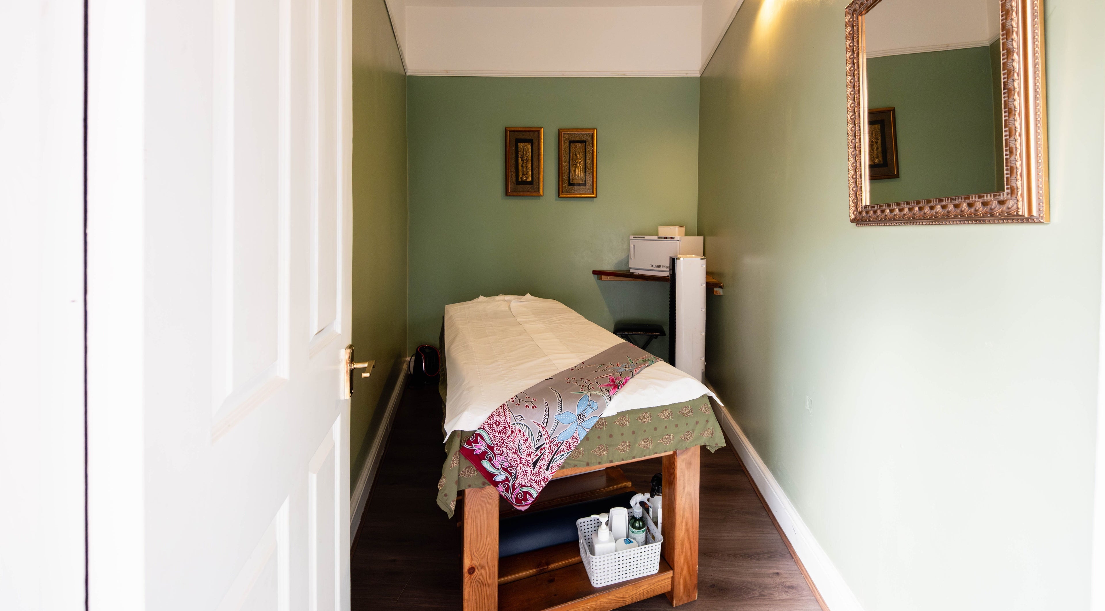 Cozy massage room at Thai London Therapy in London, England, GB, featuring a comfortable massage bed and calming decor.