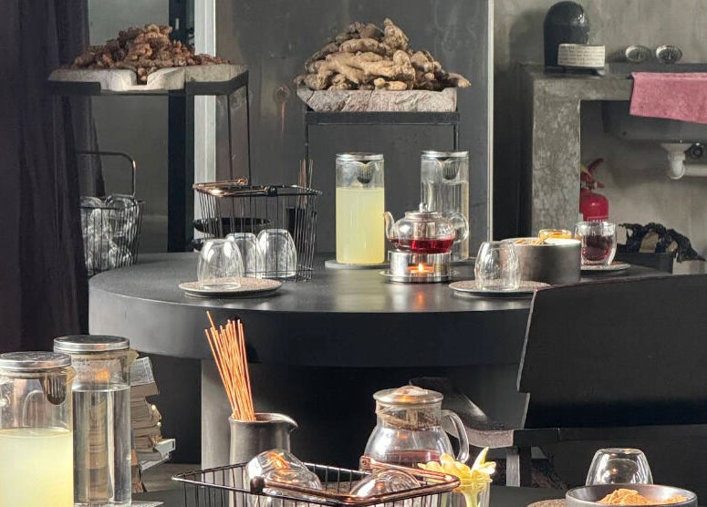 Cozy tea setup at Muka Concepts Jalan Green School, Sibang Kaja, Bali, ID with herbal displays and teapots.